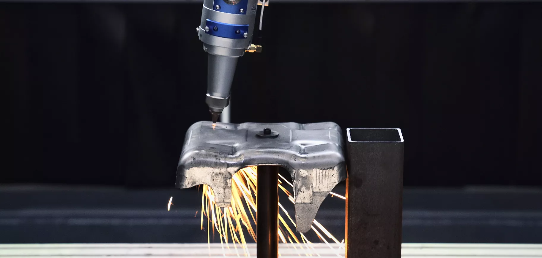 Five-axis laser cutting a formed metal part with sparks