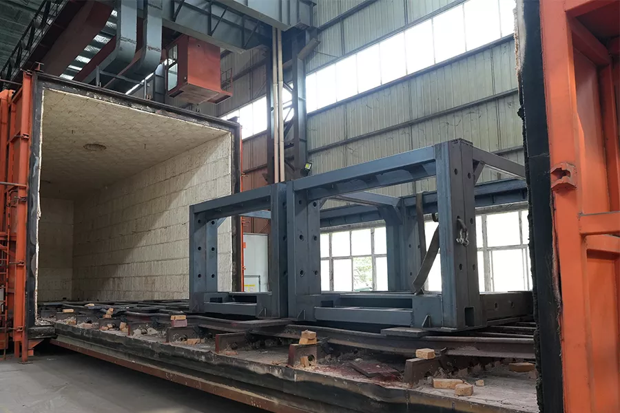 Welded machine frame entering a stress-relief annealing furnace